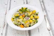 Plate of quinoa salad with mango — Stock Photo