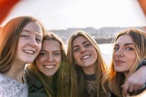 Four young women making a selfie in city — Stock Photo