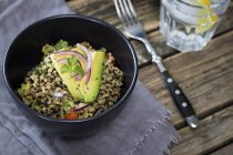 Closeup view of quinoa salad with avocado in bowl — Stock Photo