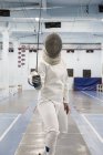 Portrait of female fencer preparing to fight — Stock Photo