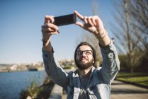 Casual young man taking a selfie outdoors, Ferrol, Galicia, Spain — Stock Photo
