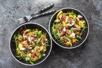 Bowls of avocado salad with rocket — Stock Photo