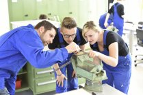 Instructor with trainees at workbench — Stock Photo