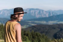 Austria, Mondsee, Mondseeberg, young man wearing a hat — Stock Photo
