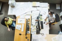 Male and female architects working in office — Stock Photo