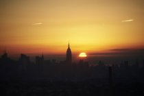 Cityscape with Empire State building at sunrise, New York City, USA — Stock Photo