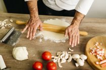 Cropped image of Chef preparing pizza at home — Stock Photo