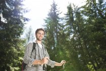 Young man on a hiking tour in the forest — Stock Photo