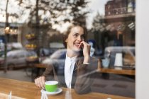Smiling young woman in a cafe — Stock Photo