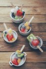 Lecca-lecca di frutta e bacche fatte in casa in ciotole su legno scuro — Foto stock