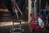 Drummer sitting next to guitar at recording studio — Stock Photo