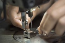 Seamstress working at sewing machine, close up — Stock Photo