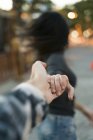 Couple in motion hand in hand outdoors — Stock Photo