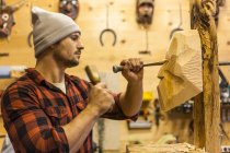 Wood carver manufacturing traditional Krampus mask — Stock Photo