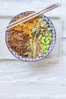 Buddha bowl of Edamame, cucumber, carrots, courgettes, Shirataki noodles and sesame — Stock Photo