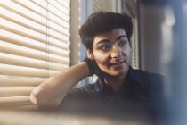 Portait of young man beside window, middle eastern ethnicity — Stock Photo