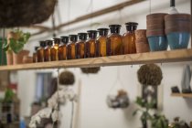 Pots and bottles on shelf — Stock Photo