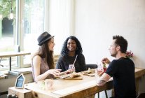 Friends meeting in cafe, eating and having fun — Stock Photo