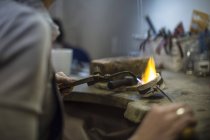 Closeup view of goldsmith working with blow torch — Stock Photo