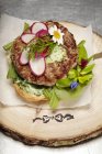 Alpine hamburger with wild herb salad — Stock Photo