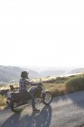 Man riding motorbike on country road — Stock Photo