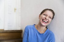 Laughing young woman on steps — Stock Photo