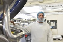 Worker in an industrial bakery — Stock Photo