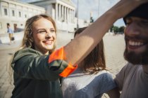 Austria, Vienna, three friends having fun in front of the parliament building — Stock Photo
