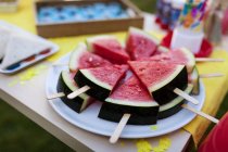 Birthday table with watermelon lollipops on plate — Stock Photo