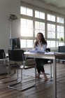 Businesswoman working at desk in office — Stock Photo