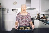 Портрет старшого жінка з приготовленої їжі на кухні — стокове фото