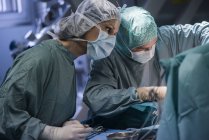 Neurosurgeon with operating room nurse during an operation — Stock Photo