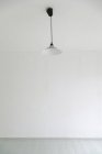 Ceiling lamp in white empty room — Stock Photo
