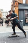 Young man riding on skateboard in Dublin, Ireland — Stock Photo