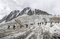 France, Chamonix, Grands Montets, Aiguille Verte, group of mountaineers hiking in winter — Stock Photo