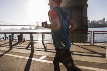 USA, New York City, man running at East River — Stock Photo