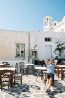 Greece, Milos, Klima, Man sitting in empty cafe and relaxing — Stock Photo