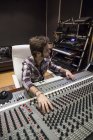 Man working in the control room of a recording studio — Stock Photo