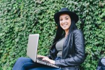 Young woman using laptop outdoors — Stock Photo