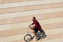 Man riding folding bicycle — Stock Photo