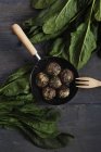 Frying pan with spinach meatballs — Stock Photo