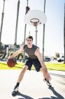 Young man at basketball training on sunny weather day — Stock Photo
