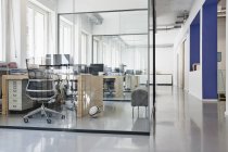 Innenraum eines hellen, modernen Büros mit separaten Glasräumen — Stockfoto