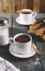 Churros with cups of hot chocolate on table — Stock Photo