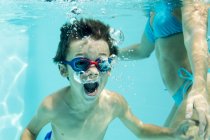 Little boy under water with air bubbles — Stock Photo