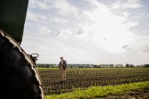 Farmer standing in a field — Stock Photo