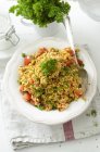 Closeup view of bulgur salad with tomatoes and parsley — Stock Photo