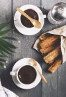 Churros with cups of hot chocolate — Stock Photo
