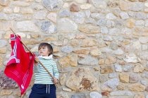 Portrait of little boy with red flag playing hero — Stock Photo