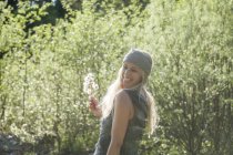 Portrait of laughing blond woman with an umbel in nature — Stock Photo